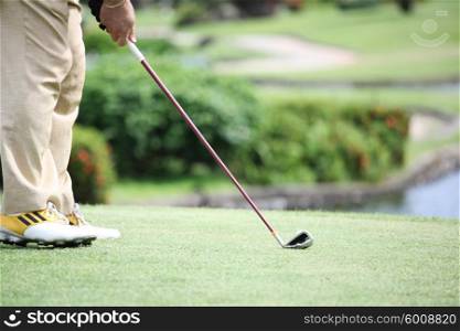 Golfer hitting golf shot . Golfer hitting golf shot with club on course