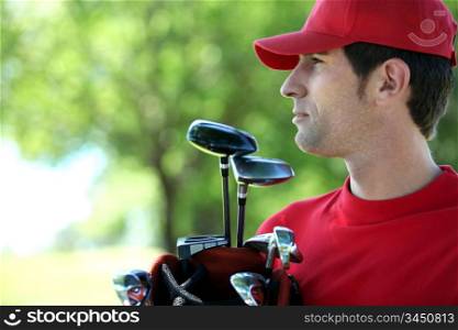 Golfer holding golf bag