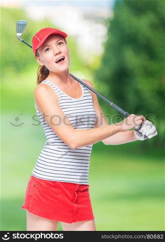 Golfer in cap with golf club on a background of golf courses