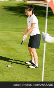 Golfer Preparing to Sink Putt