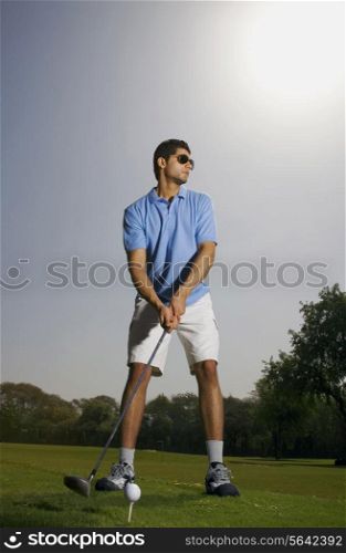 Golfer tees off
