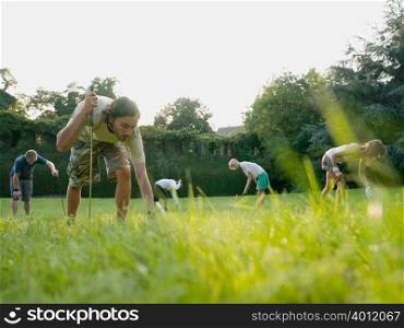 Golfers searching in grass