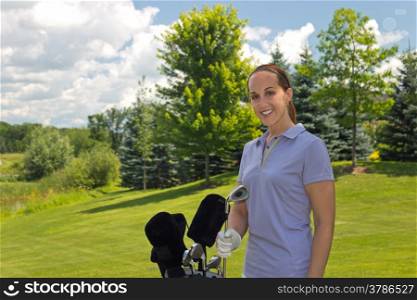 Golfing woman with her golf bag on the course