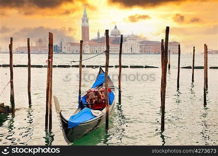 Gondola at sunset pier near San Marco square in Venice, Italy