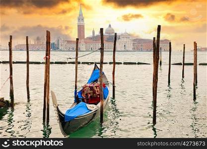Gondola at sunset pier near San Marco square in Venice, Italy