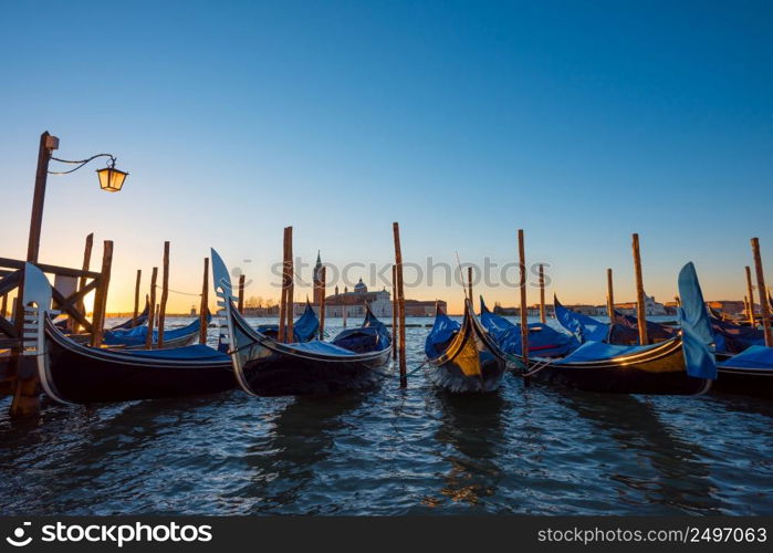 Gondola boats. Venice Italy gondola boats at seafront near San Marco square at sunrise.