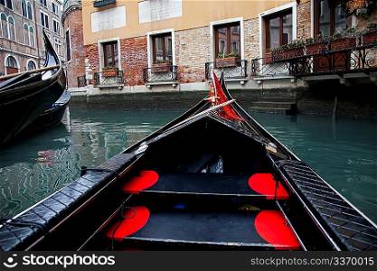 Gondola sailing in Venice channel, Italy