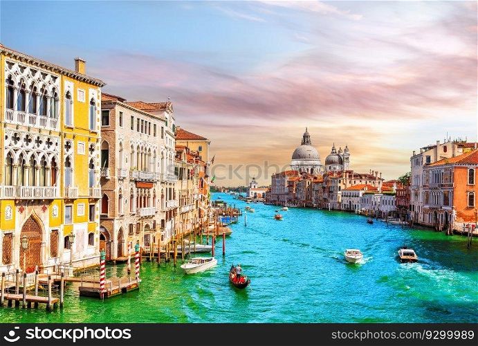 Gondolas and boats in the Grand Canal of Venice near Santa Maria della Salute, Italy.