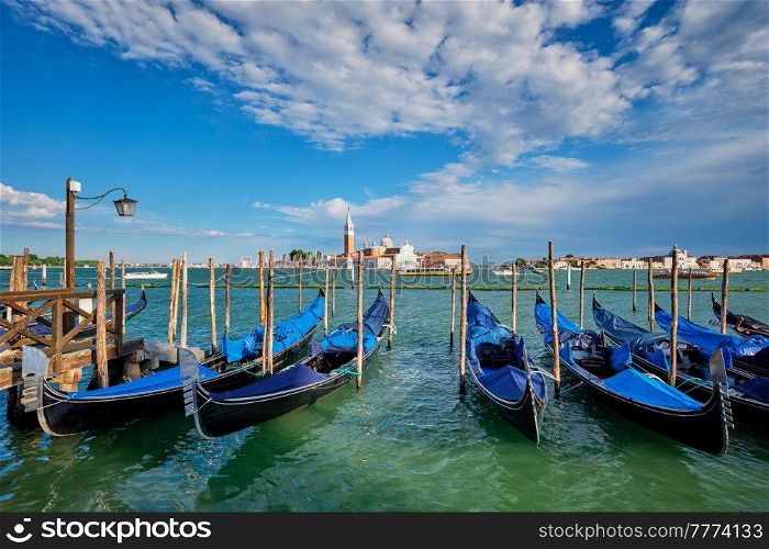 Gondolas and in lagoon of Venice by Saint Mark (San Marco) square with San Giorgio di Maggiore church in background in Venice, Italy. Gondolas and in lagoon of Venice by San Marco square. Venice, Italy