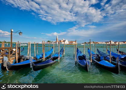 Gondolas and in lagoon of Venice by Saint Mark (San Marco) square with San Giorgio di Maggiore church in background in Venice, Italy. Gondolas and in lagoon of Venice by San Marco square. Venice, Italy