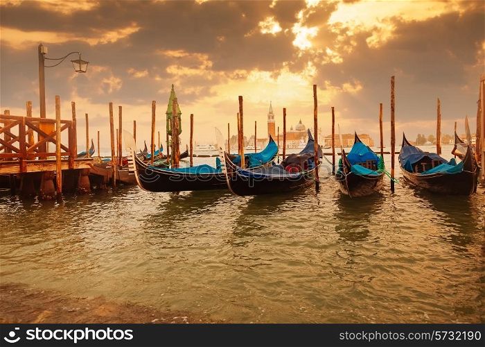 Gondolas at sunset pier near San Marco square in Venice, Italy&#xA;
