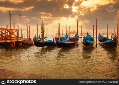 Gondolas at sunset pier near San Marco square in Venice, Italy&#xA;