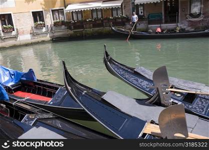 Gondolas docked in a canal, Venice, Italy