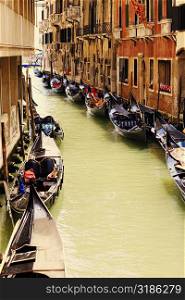 Gondolas docked on both sides of a canal, Venice, Italy