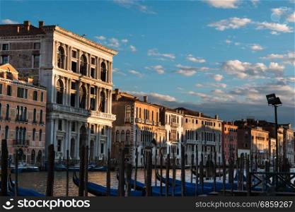 Gondolas, Grand Canal and Typical Houses in a Summer Day in Venice, Italy