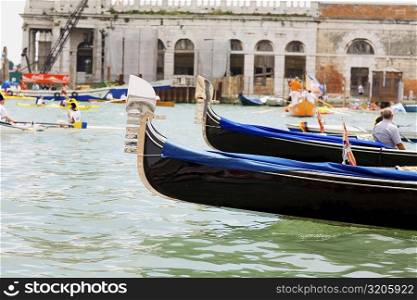Gondolas in a canal in front of buildings, Regatta Storica, Venice, Italy