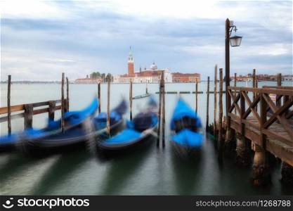 Gondolas in Venice, Italy from St Mark&rsquo;s Square (Piazza san Marco) with gorgeous view of San Giorgio Maggiore Church. Venice is famous travel destination of Italy for its unique cityscape and culture.