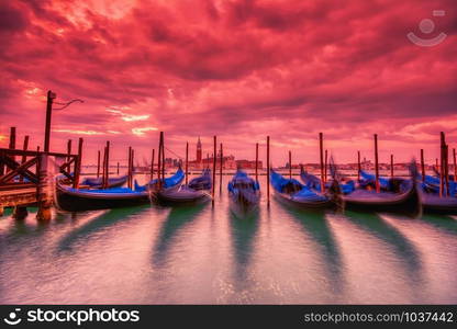 Gondolas moored by Saint Mark square on the Grand canal at dawn in Venice, Italy, Europe. Long exposure.