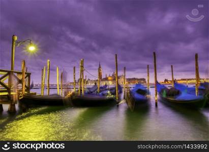 Gondolas moored by Saint Mark square on the Grand canal at dawn in Venice, Italy, Europe. Long exposure.