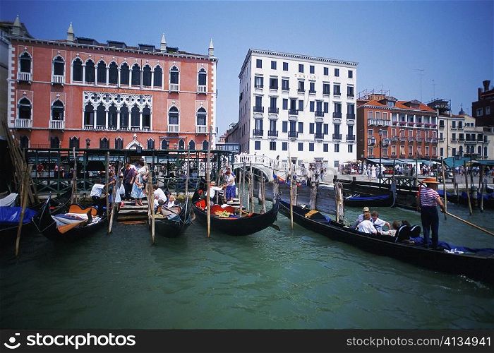 Gondolas moored in a canal in front of buildings, Grand Canal, Venice, Veneto, Italy