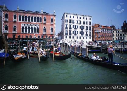 Gondolas moored in a canal in front of buildings, Grand Canal, Venice, Veneto, Italy