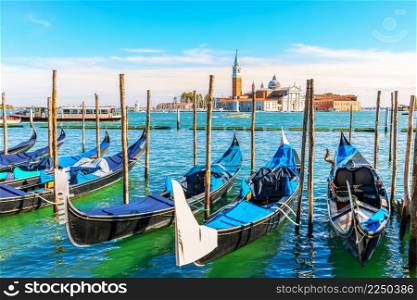 Gondolas moored in the lagoon of Venice not far from San Giorgio Maggiore Island, Italy.. Gondolas moored in the lagoon of Venice not far from San Giorgio Maggiore Island, Italy