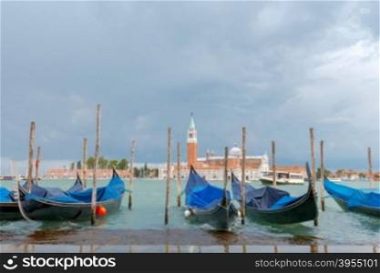 Gondolas moored near San Marco square on the background of San Giorgio Maggiore.. Venice. San Giorgio Maggiore.