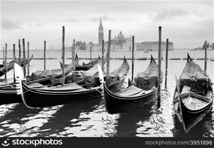 Gondolas near Saint Mark square in Venice, Italy. Black and white image.
