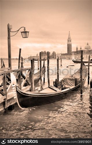 Gondolas near Saint Mark square in Venice, Italy. Black and white image, sepia toned