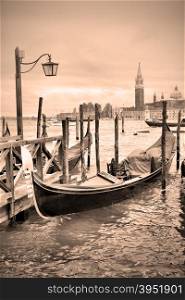 Gondolas near Saint Mark square in Venice, Italy. Black and white image, sepia toned