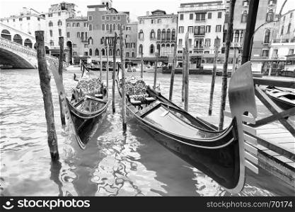 Gondolas on Grand Canal near Realto bridge in Venice, Italy. Black and white