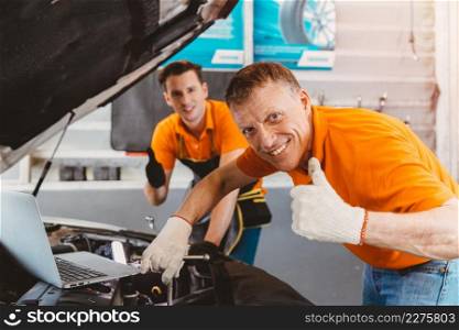 good car service staff happy mechanic teamwork for engine check