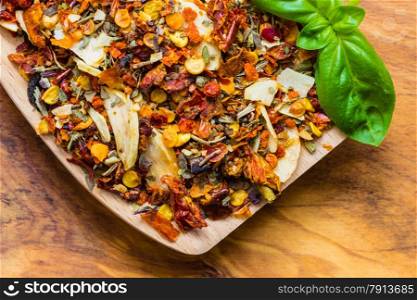 Good cuisine. Closeup colored spices for pasta mix and fresh basil leaf on wooden spoon