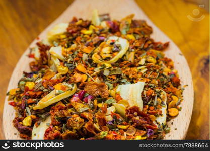 Good cuisine. Closeup colored spices for pasta mix on wooden spoon