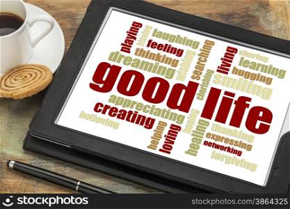 good life - cloud of positive words on a digital tablet with a cup of coffee