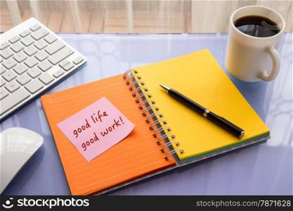 Good life Good work word on note pad stick on blank colorful paper notebook at home office table