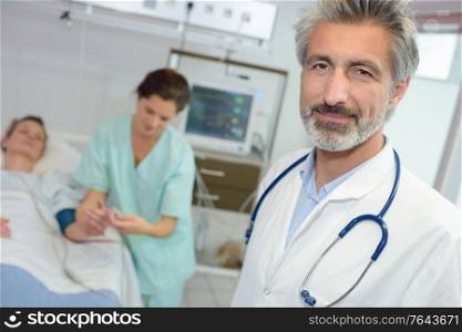 good looking latin doctor standing in a hospital room