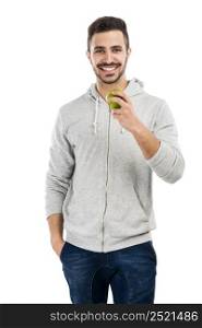 Good looking latin man eating a green apple, isolated on white background