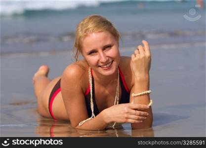good looking woman rolling around in the surf