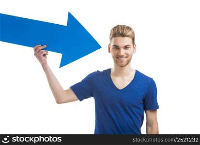 Good looking young man holding a blue arrow, isolated on a white background