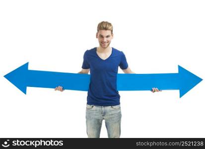 Good looking young man holding a blue arrow, isolated on a white background