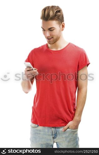Good looking young man sending a text message