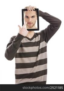 Good looking young man showing a tablet with is own picture on it