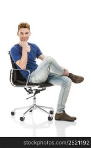 Good looking young man sitting on a chair, isolated on white background