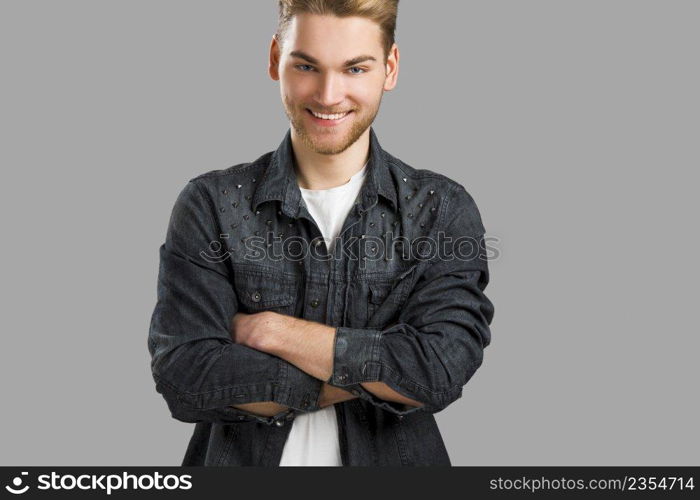 Good looking young man smiling and looking to the camera, isolated on white background