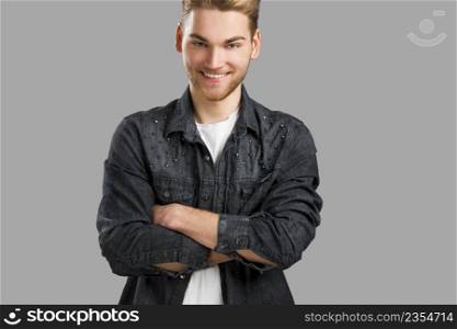 Good looking young man smiling and looking to the camera, isolated on white background