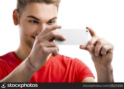 Good looking young man taking a selfie with his cell phone