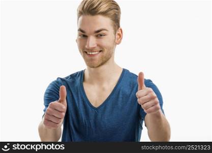Good looking young man with a smiley face and thumbs up, isolated on white background