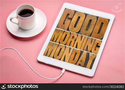 Good Morning Monday word abstract - text in vintage letterpress wood type printing blocks on a digital tablet with a cup of coffee