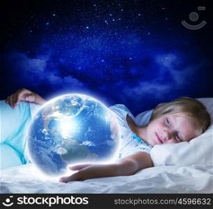 Good night. Girl in bed with Earth planet in hands. Elements of this image are furnished by NASA